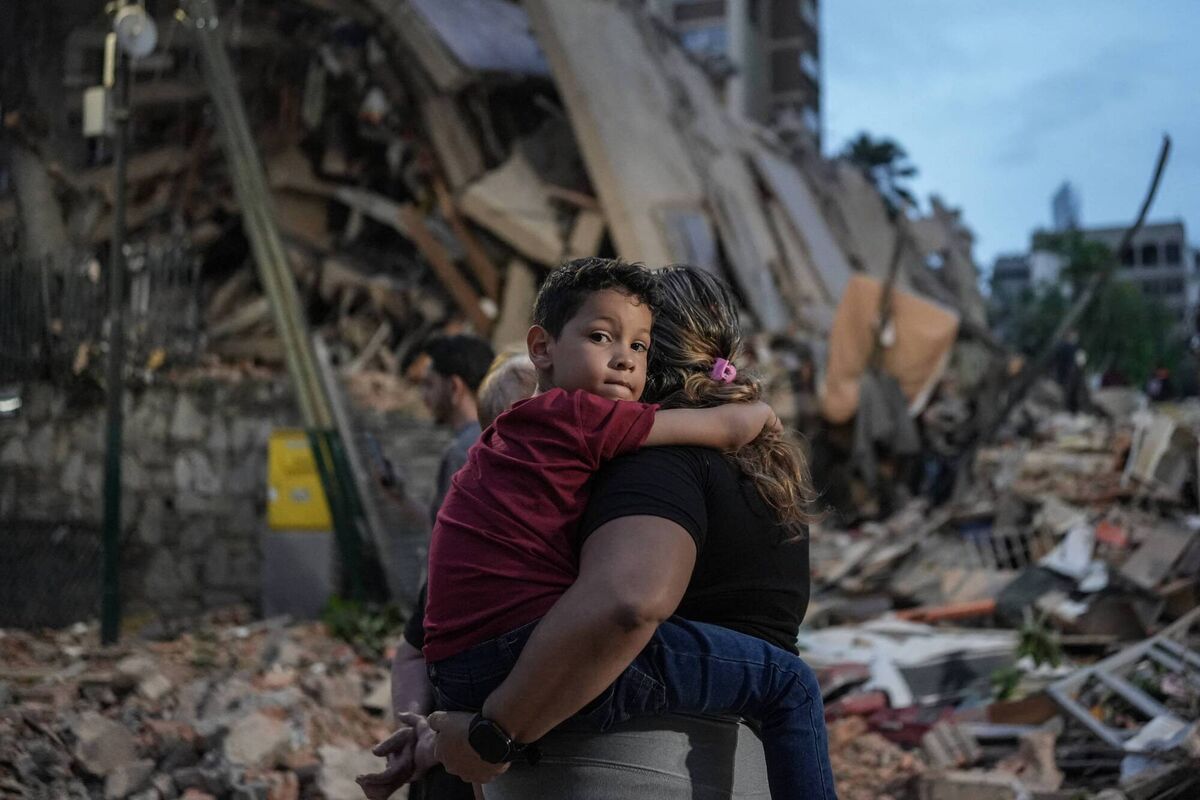 People walk past a collapsed building following an earthquake in Caracas on June 25. Picture: Manaure Quintero/AFP via Getty Images People walk past a collapsed building following an earthquake in Caracas on June 25. Picture: Manaure Quintero/AFP via Getty Images
