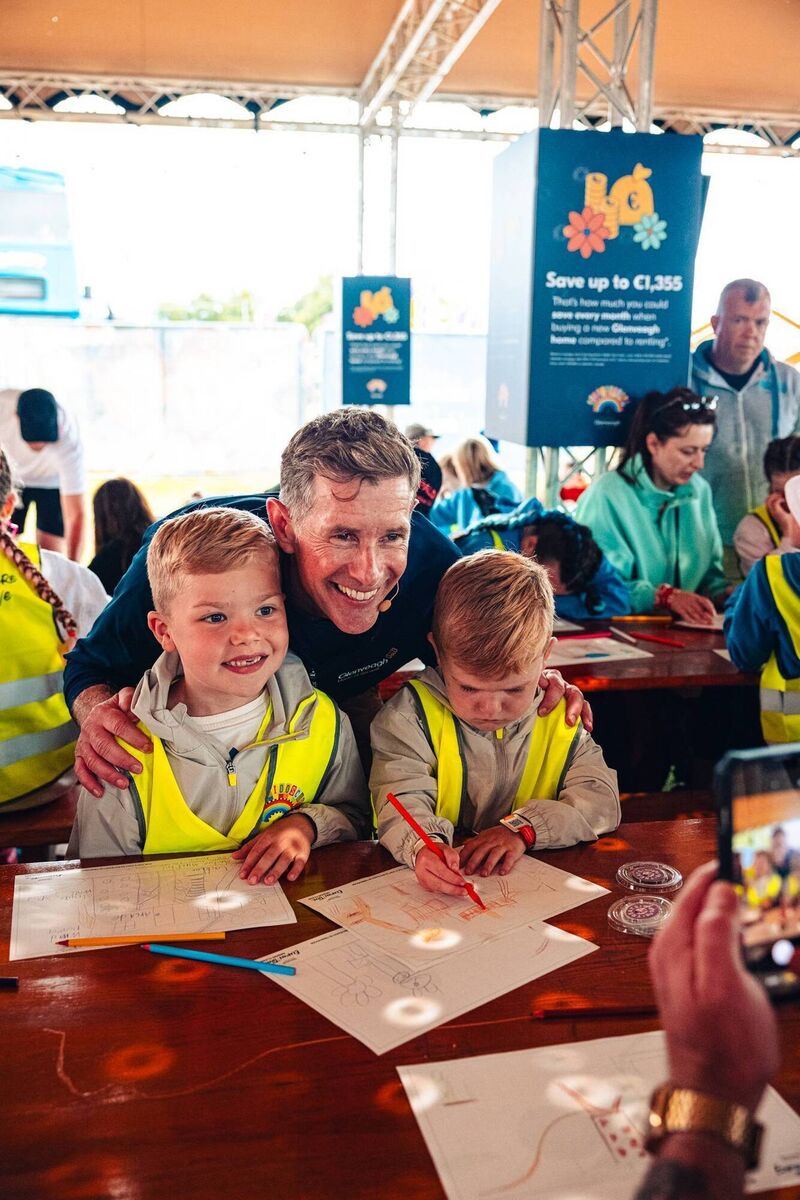 Dermot Bannon poses for a photo with festival goers at his treehouse building workshop