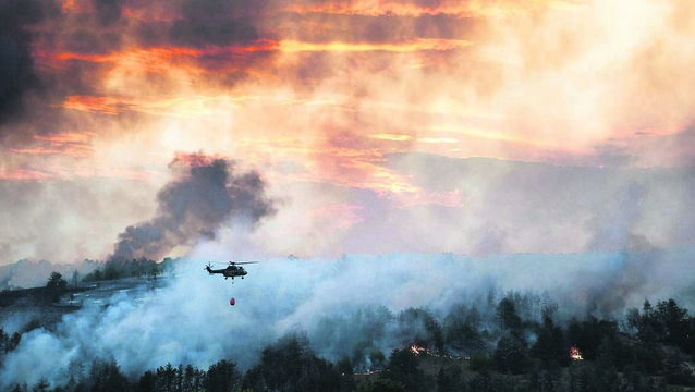 <p>A firefighting helicopter flies over a forest wildfire, dumping water from a bucket to help tackle the blaze. Europe is warming faster than any other continent, and hotter summers are increasing what fire scientists call ‘fire weather’, periods of prolonged heat, dry vegetation and strong winds that favour rapid fire growth.	<span class="contextmenu emphasis CaptionCredit">Picture: iStock</span>
            </p>