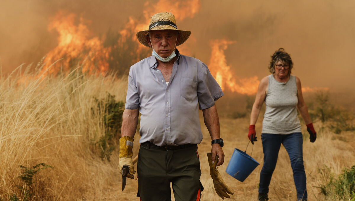 Local residents do what they can to fight the flames during a wildfire in Santa Baia De Montes, northwestern Spain, in August last year. Picture: AP Local residents do what they can to fight the flames during a wildfire in Santa Baia De Montes, northwestern Spain, in August last year. Picture: AP