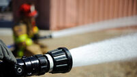 Firefighters spray water during a training exercise.