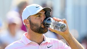 <p>SCOTTIE'S TOO HOTTIE: Scottie Scheffler takes a drink on the 15th hole during day two of the Genesis Scottish Open 2026 at The Renaissance Club, North Berwick. Pic: Malcolm Mackenzie/PA Wire.</p>