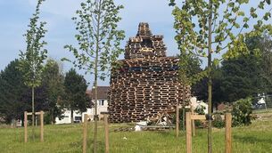 <p>The bonfire in the Braniel estate in east Belfast where a man died in an accident on Friday night (Jonathan McCambridge/PA)</p>