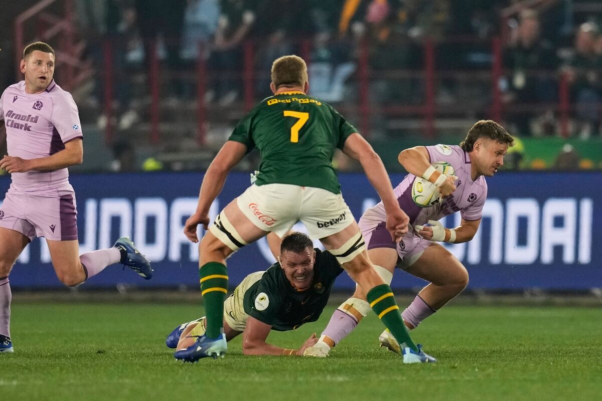 Scotland's Kyle Rowe, right, is tackled by South Africa's Cobus Wiese. Pic: Themba Hadebe/AP