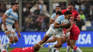 <p>Argentina's Santiago Carreras is tackled by Wales's Blair Murray, left, and Tomos Williams. Pic: Gustavo Garello/AP</p>