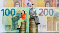 Figures of male and female people on different piles of money coins, concept of income inequality