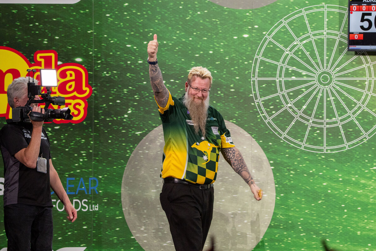 Aussie darts star Simon Whitlock arrives on stage at the Marquee Masters. Picture by Noel Sweeney