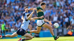 <p>Kerry's David Clifford scores his side's first goal of the match despite Dublin's David Byrne</p>