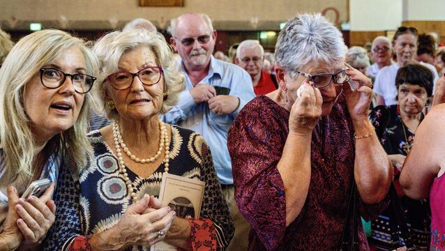 <p>One member of the congregation wipes away a tear during the emotional final Mass at St Augustine’s Church in Cork. The church officially seats 1,200, but one priest estimated the congregation spilling out into Washington Stand the Grand Parade was close to 2,000. Pictures: Chani Anderson</p>