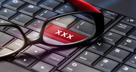 Adult content button through reading glasses.
