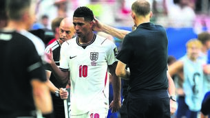 <p>SAVED BY THE BELL: Jude Bellingham is greeted by manager Thomas Tuchel after being substituted during Saturday’s World Cup quarter-final at the Miami Stadium. Pic: Martin Rickett/PA</p>