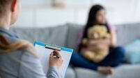 Teenage depression. Psychologist working with teen girl at office, talking to her patient, taking notes, selective focus