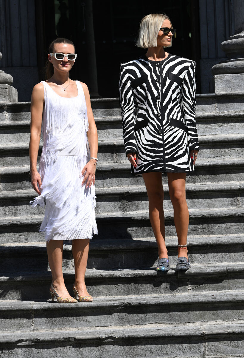 Cait McGettigan (left) models a Tom Ford white fringe two-piece (shoes are model's own - not part of the collection). Ali wears Prada diamante heels and a Dolce &amp; Gabbana blazer-style dress. Picture: Larry Cummins