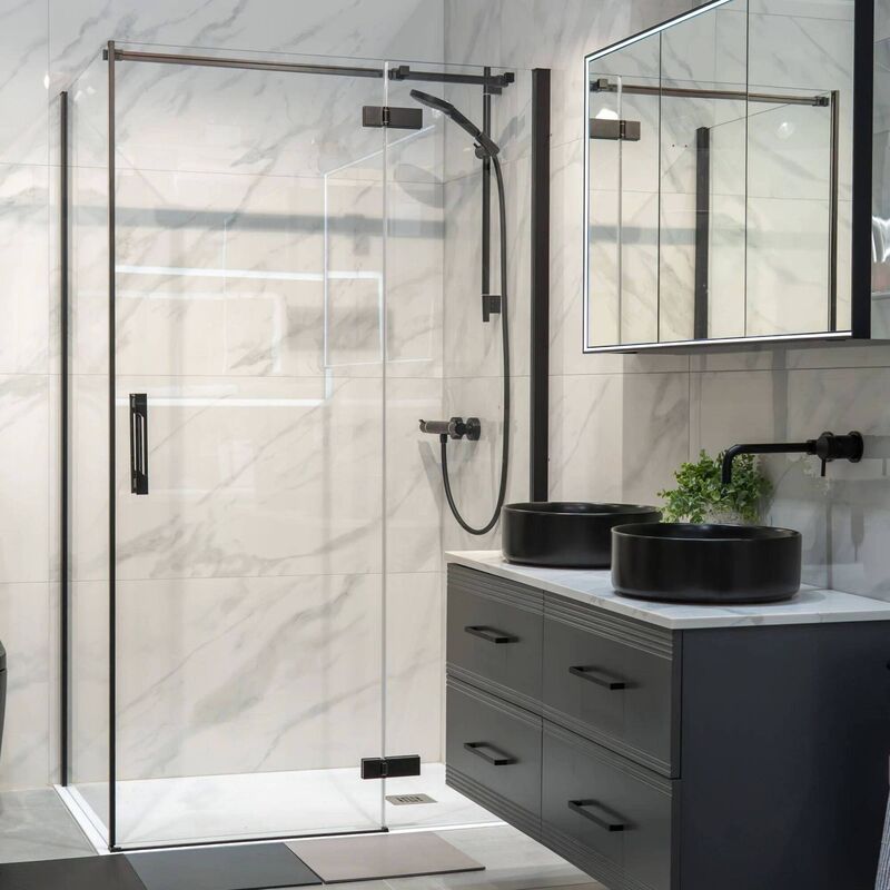 Hinge and inline shower door with side panel, matt black, from €1033, Deluxe Bathrooms.