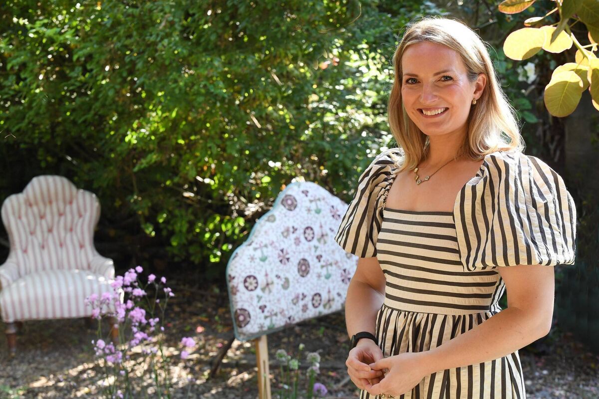 Sara Harrison with a chair and headboard she has reupholstered. Picture: Moya Nolan Sara Harrison with a chair and headboard she has reupholstered. Picture: Moya Nolan