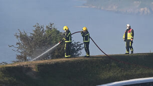 <p>Firefighters battling the gorse fire near Camden Forth Meagher in Crosshaven, yesterday. Picture: Eddie O'Hare.</p>