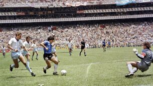 <p>GOAL OF GOD: Argentinian forward Diego Armando Maradona runs past English defender Terry Butcher on his way to dribbling goalkeeper Peter Shilton and scoring. Pic: STAFF/AFP via Getty Images.</p>