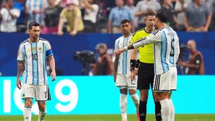 <p>Argentina's Leandro Paredes (right) appeals to referee Francois Letexier. Pic: Nick Potts/PA Wire.</p>