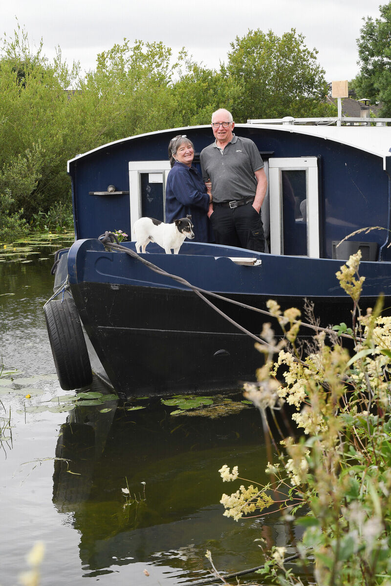 Alistair and Tracey Morrish with their dog Buzz on the barge they call home near Lucan, Co. Kildare. Picture: Moya Nolan