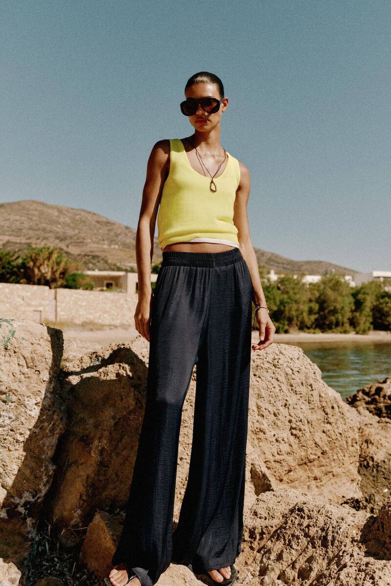 A model posing in Zara's flowy wide-leg trousers A model posing in Zara's flowy wide-leg trousers