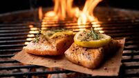 Low Carb Salmon Filet with Lemon Slices on a Fiery Grill