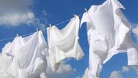 iStock-1484940836.jpg Clean clothes hanging on washing line against sky. Drying laundry