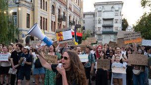 People gather to denounce President Volodymyr Zelensky’s decision to dismiss defence minister Mykhailo Fedorov (Danylo Antoniuk/AP)