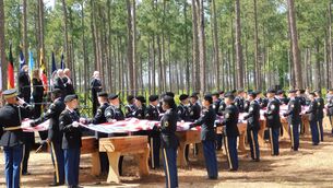 Military personnel fold flags for the remains of 12 Continental soldiers killed at the Battle of Camden (Historic Camden Foundation/via AP) Military personnel fold flags for the remains of 12 Continental soldiers killed at the Battle of Camden (Historic Camden Foundation/via AP)