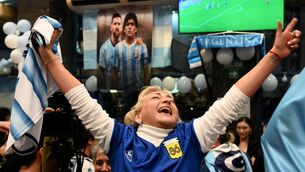<p>A fan celebrates at a restaurant in Buenos Aires after Argentina beat England in the semi-final on July 15. Picture: Luis Robayo/AFP via Getty</p>