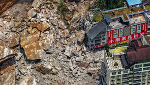Rescuers conduct search and rescue operation on the site of the landslide in China’s Chongqing (Huang Wei/Xinhua via AP)