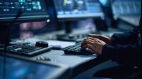 Close Up of a Professional Office Specialist Working on Desktop Computer in Modern Technological Monitoring Control Room with Di