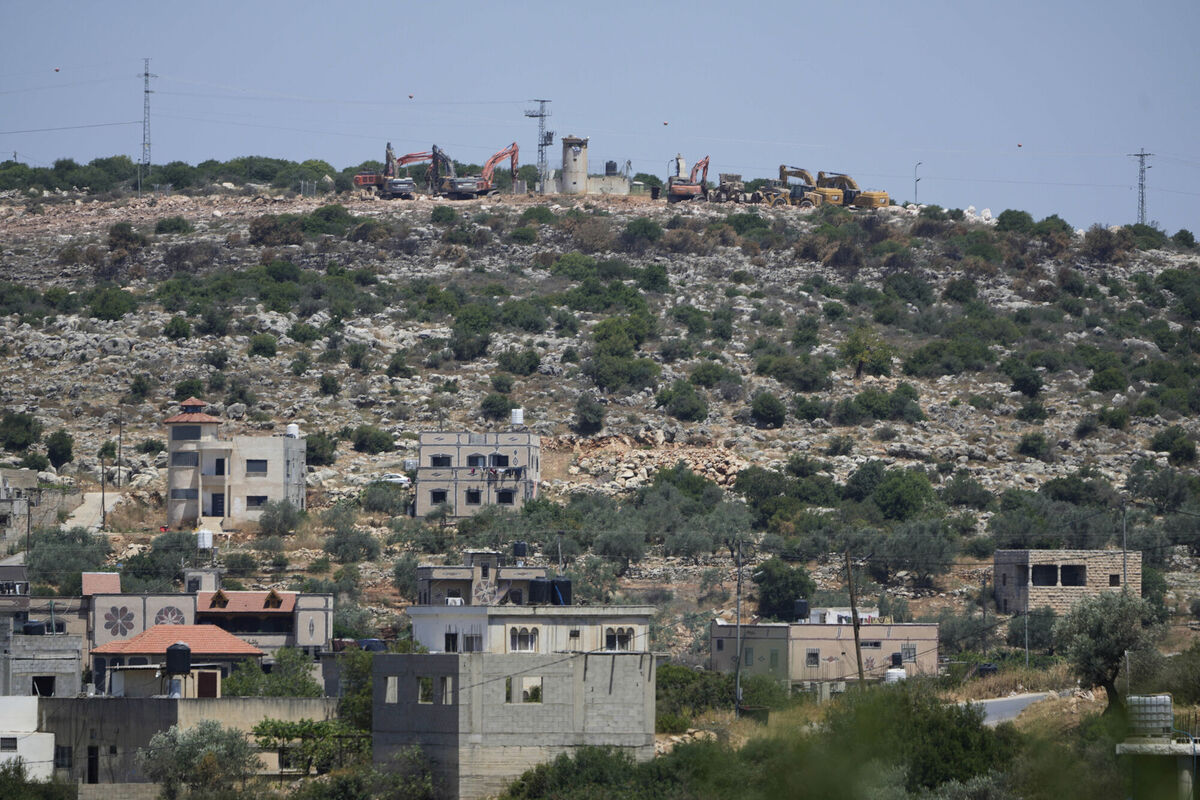 Bulldozers work by an Israeli settlers outpost, near the Israeli settlement of Bruchin, on top of a hill and overlooking the adjacent West Bank village of Bruqin. (AP Photo/Nasser Nasser) Bulldozers work by an Israeli settlers outpost, near the Israeli settlement of Bruchin, on top of a hill and overlooking the adjacent West Bank village of Bruqin. (AP Photo/Nasser Nasser)