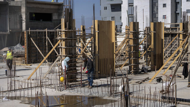 <p>Palestinian laborers work at the site of a new housing project in the West Bank Jewish Settlement of Beit El. (AP Photo/Ohad Zwigenberg, File)</p>