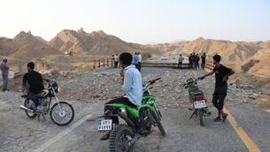 People stand on a bridge destroyed after a strike in Hormozgan province, southern Iran (Amirhosein Khorgooi/Iranian Students’ News Agency/AP) People stand on a bridge destroyed after a strike in Hormozgan province, southern Iran (Amirhosein Khorgooi/Iranian Students’ News Agency/AP)