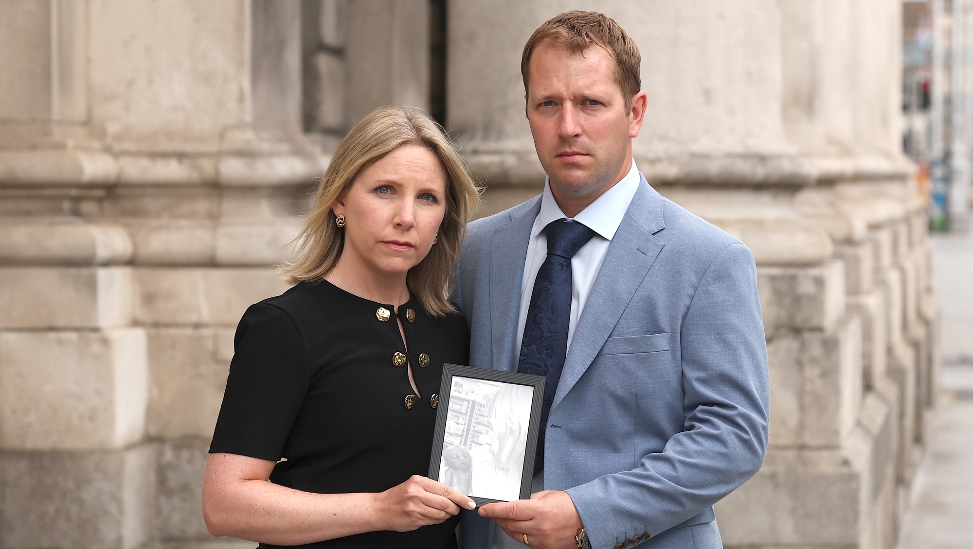 Áine and John Duggan from Sweeney's Hill, Rathpeacon, Co Cork, holding a photo of their son George, at the High Court on Tuesday. Picture: Collins Courts