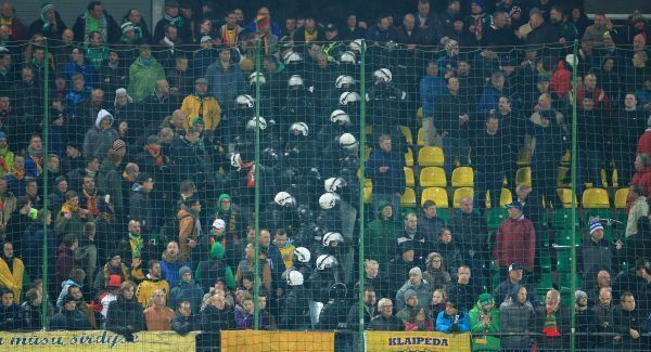 Riot Police separate Lithuania and England fans in the stands at the LFF Stadium. Photo: Nick Potts/ PA