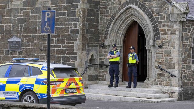 <p>Gardaí at the scene of the serious assault at the Holy Cross Church in Tramore. Photo: Patrick Browne</p>