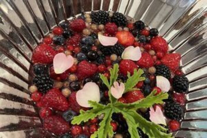 Summer currant and berry fruit salad with sweet geranium leaves