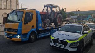 <p>The tractor towed away after its seizure by gardaí. Photo: An Garda Siochána Mayo</p>