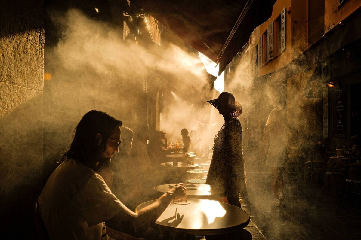 People stand in front of a coffe shop during a heatwave in the French Riviera city of Nice on July 6, 2026. Picture: Valery HACHE / AFP via Getty Images People stand in front of a coffe shop during a heatwave in the French Riviera city of Nice on July 6, 2026. Picture: Valery HACHE / AFP via Getty Images