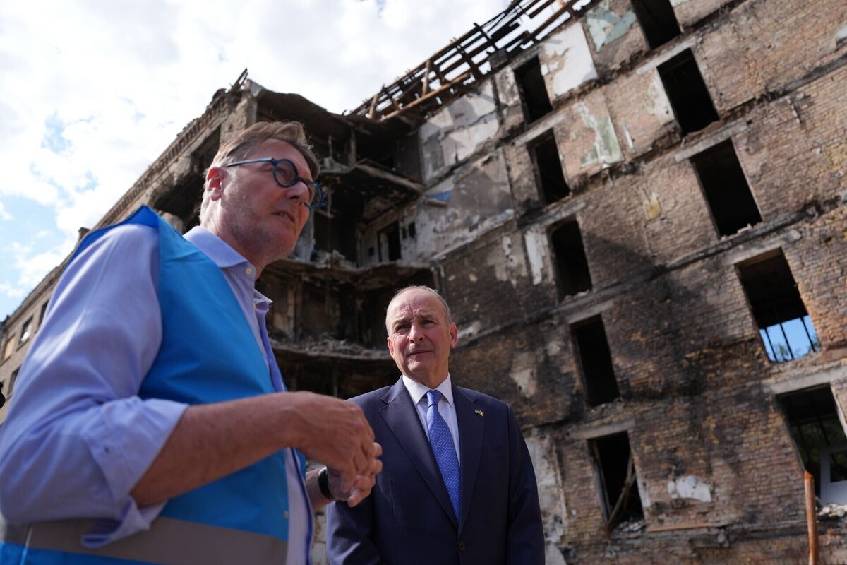 UNHCR Ukraine deputy representative Marcel Grogan showing Taoiseach Micheál Martin around the bomb-damaged Lukianivska district of Kyiv, Ukraine, on Thursday. Picture: Niall Carson/PA