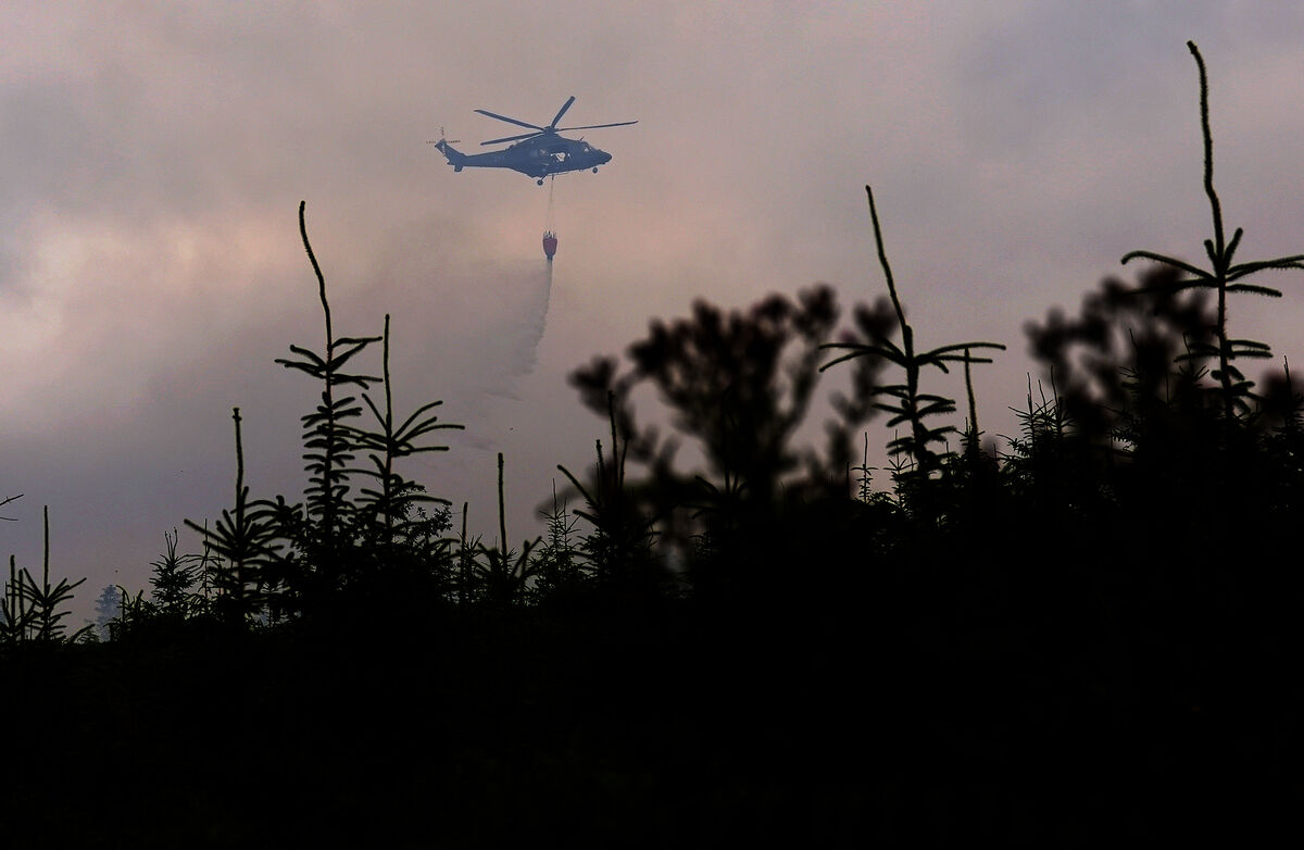 Members of the air corps provide aerial support in tackling a major wildfire as it continues to burn at Slievenamon. Picture: PA