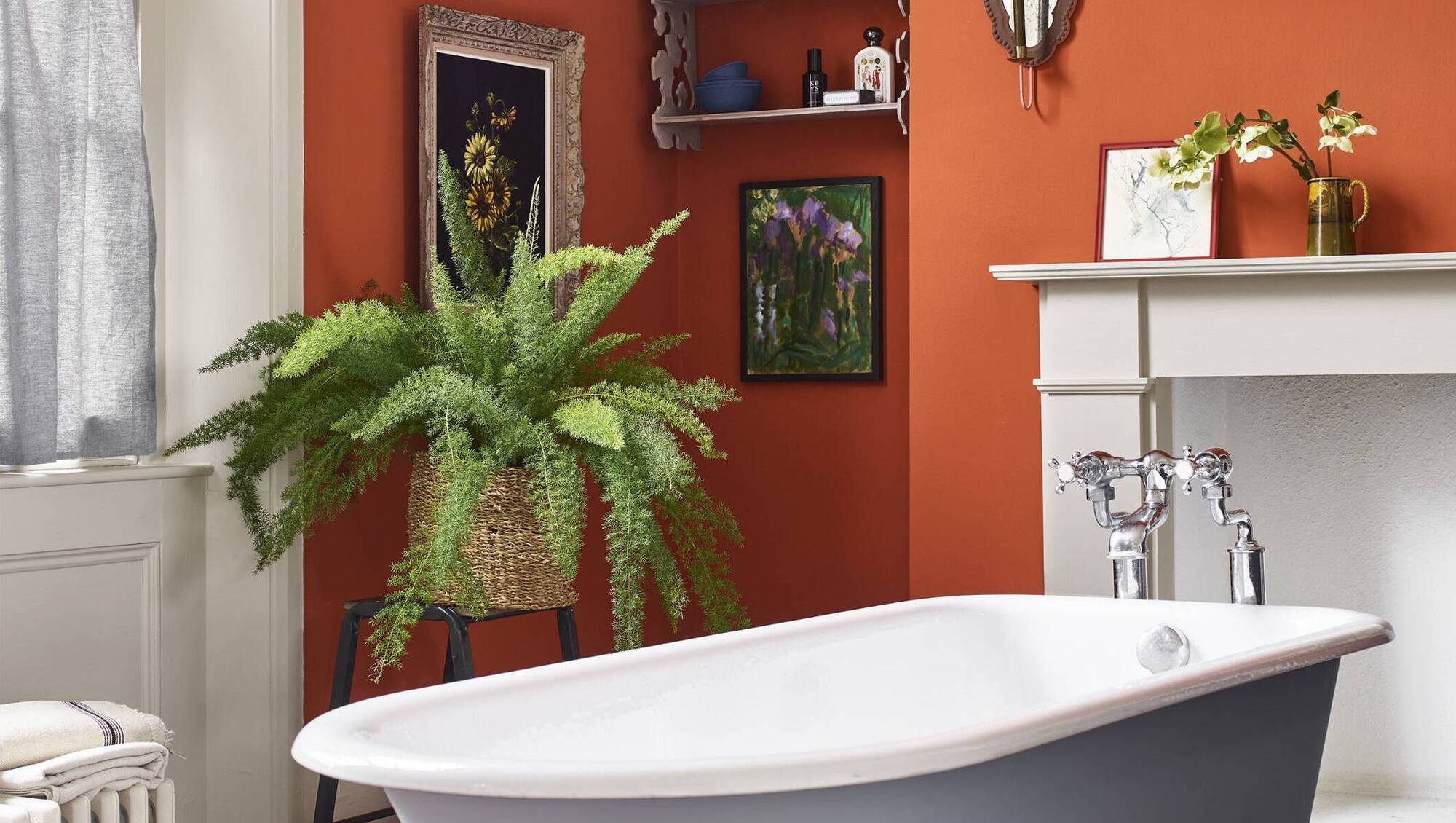 A small gallery of paintings and objects d'art is taken to the relatively dry Zone 2 of the bathroom in a curated collection. Canvas, Riad Terracotta and Louis Blue in Satin Paint, Annie Sloane; €38.95 for 750ml.