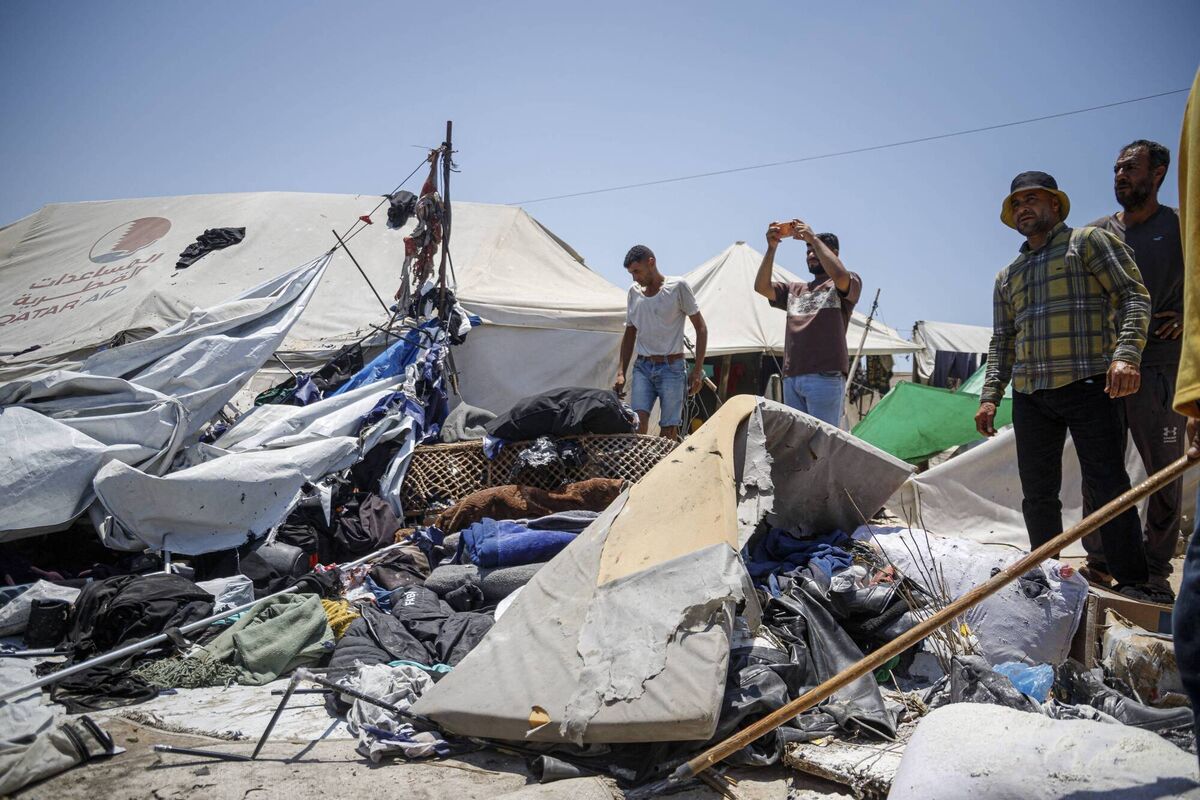 Palestinian men gather around a destroyed tent and scattered belongings in Gaza City, Gaza Strip, on July 7, following an Israeli drone strike. Picture: Mohammed M Skaik/Middle East Images/AFP/Getty Palestinian men gather around a destroyed tent and scattered belongings in Gaza City, Gaza Strip, on July 7, following an Israeli drone strike. Picture: Mohammed M Skaik/Middle East Images/AFP/Getty