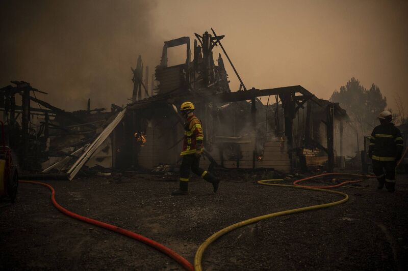 Firefighters operate next to a burning building of a residential area during a wildfire near Lege Cap Ferret, southwestern France on July 23, 2026. Picture: JULIEN DE ROSA / AFP via Getty Images