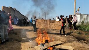Rubble set on fire as health and frontline workers protest at the Elikya Ebola Treatment Centre in Bunia, Congo (Constant Same Bagalwa/AP)