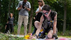 Ashley Jump lays flowers near the scene where a car rammed into a crowd (Markus Schreiber/AP) Ashley Jump lays flowers near the scene where a car rammed into a crowd (Markus Schreiber/AP)