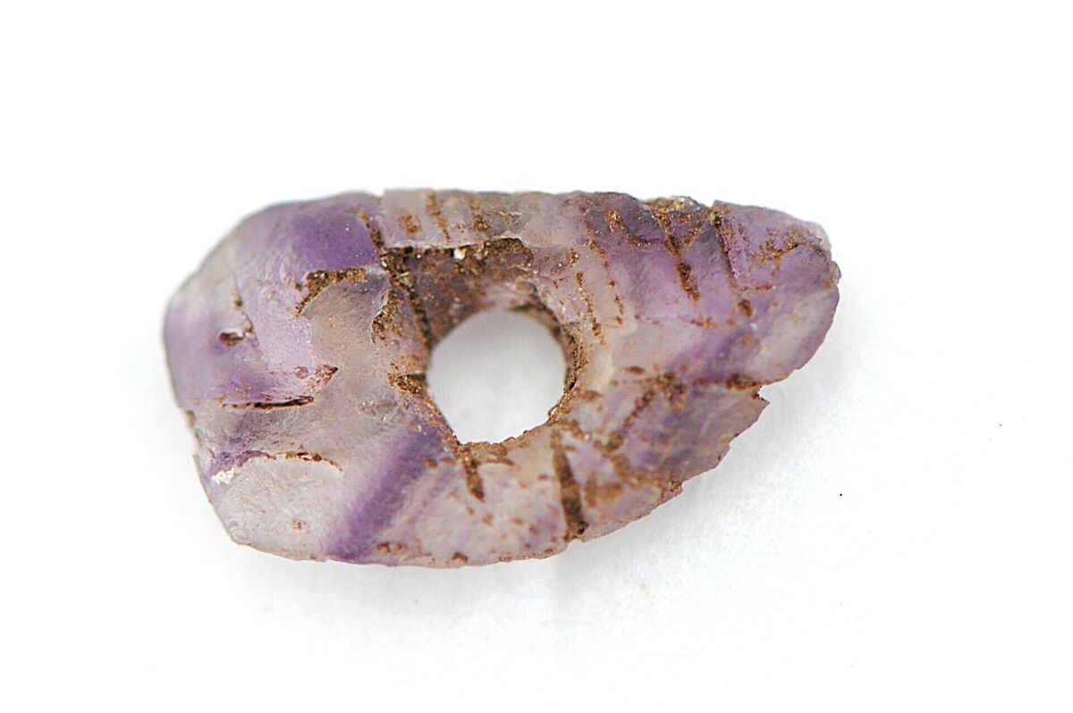 An amethyst pendant uncovered during the University of Galway archaeological excavations at the tombs site. Picture: Dr Michelle Comber/University of Galway/PA Wire An amethyst pendant uncovered during the University of Galway archaeological excavations at the tombs site. Picture: Dr Michelle Comber/University of Galway/PA Wire