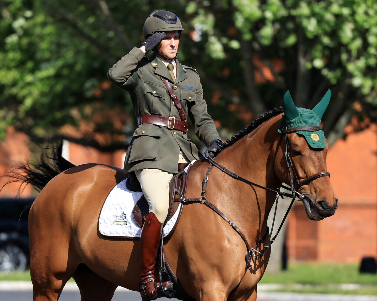 Lt. Raphael Lee salutes during the National Anthem on his horse, Bon Mahon