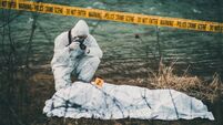 Photographer taking photos of crime scene by the river